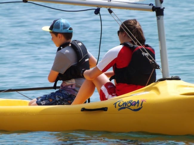 Dyl learning to sail on holiday.