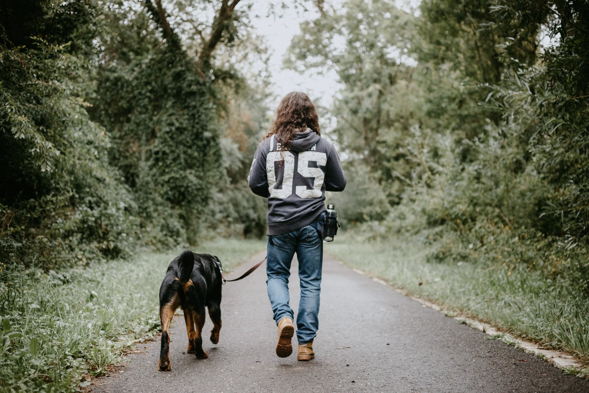 man holdingwalking dog having some festive fun