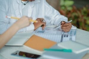 faceless multiethnic women studying with books