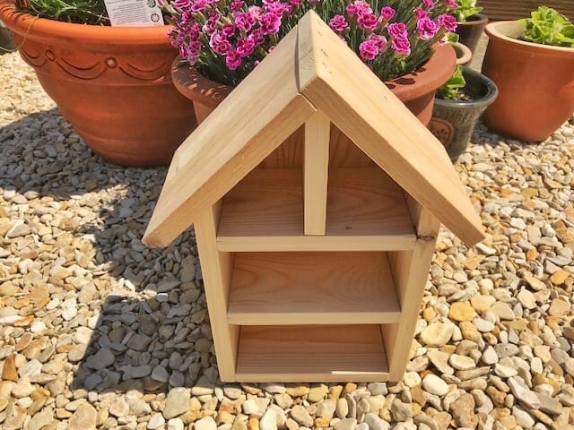 finished (empty) untreated bug hotel on gravel