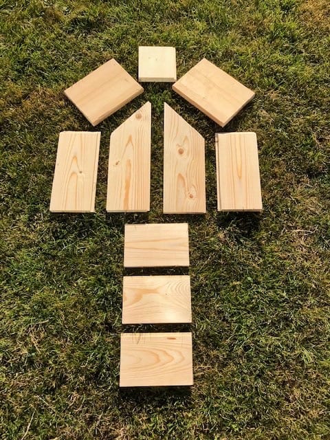image of all the cut pieces of floorboard to the correct dimensions laid on grass