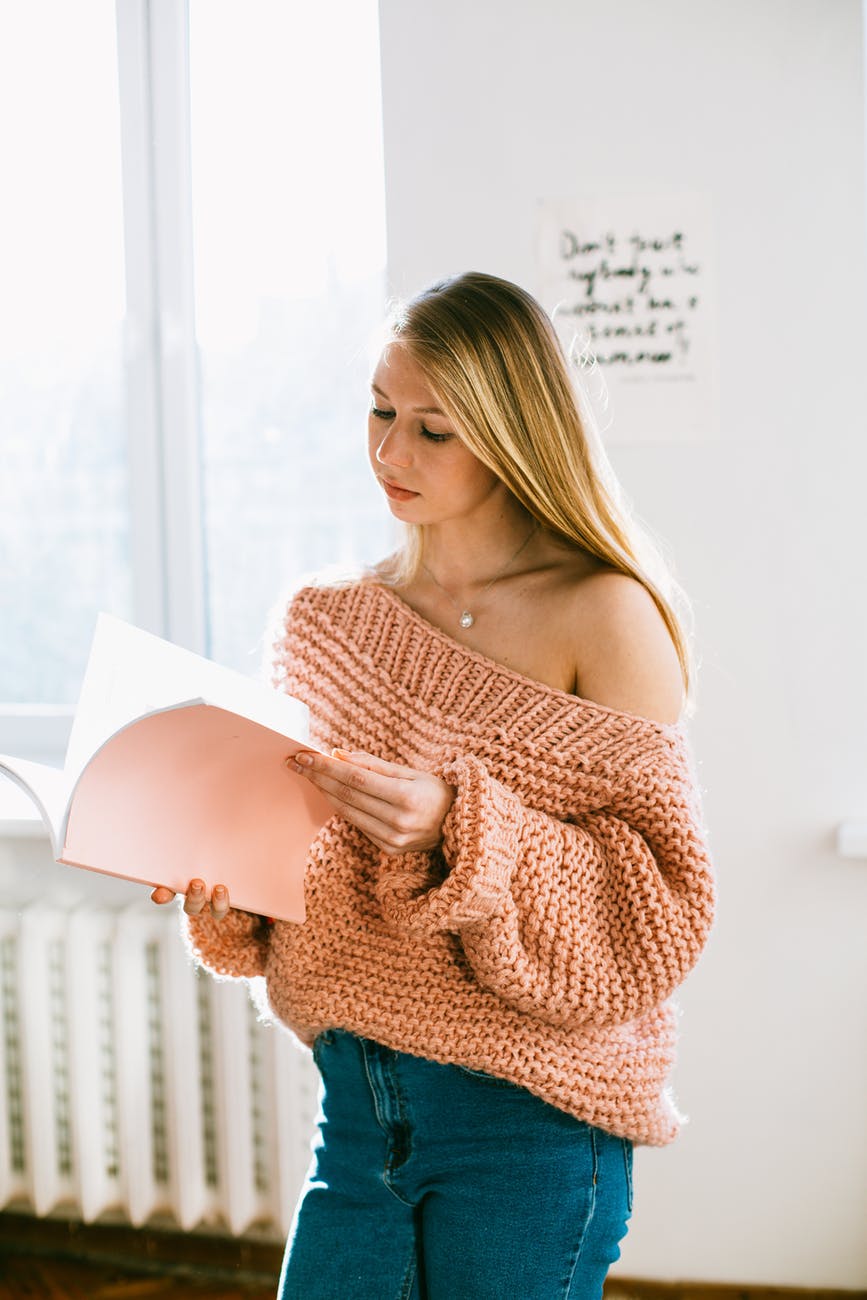 serious female student with notepad at home